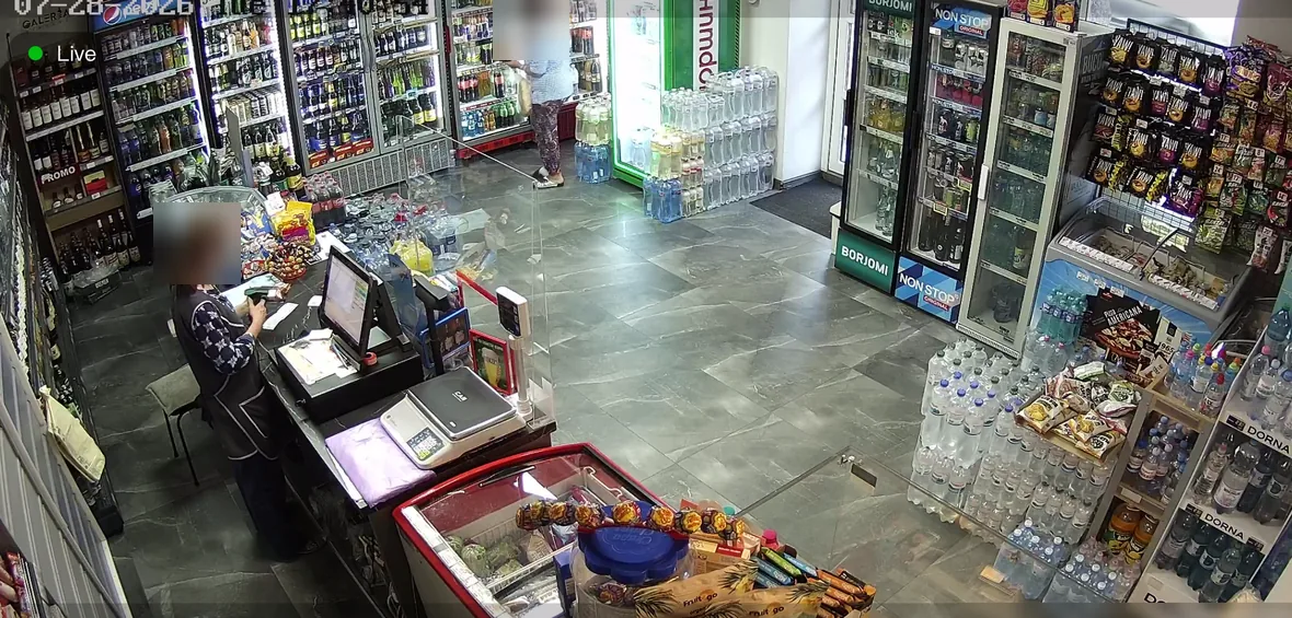 Камера видеонаблюдения в магазине: касса и вход